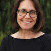 Photo of Althea Erickson, a white woman with shoulder length, brown hair and glasses